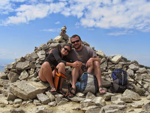 Kristal Jones and Brandn Green sitting and smiling on a pile of rocks